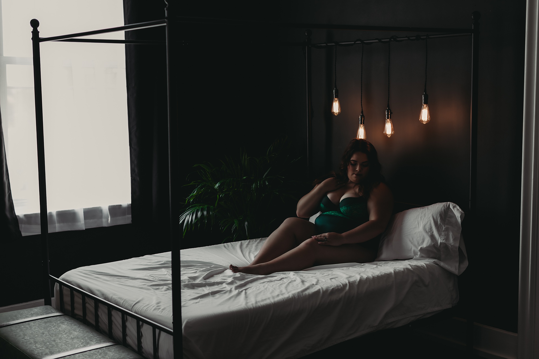 woman sitting in bed for Grand Haven MI boudoir shoot