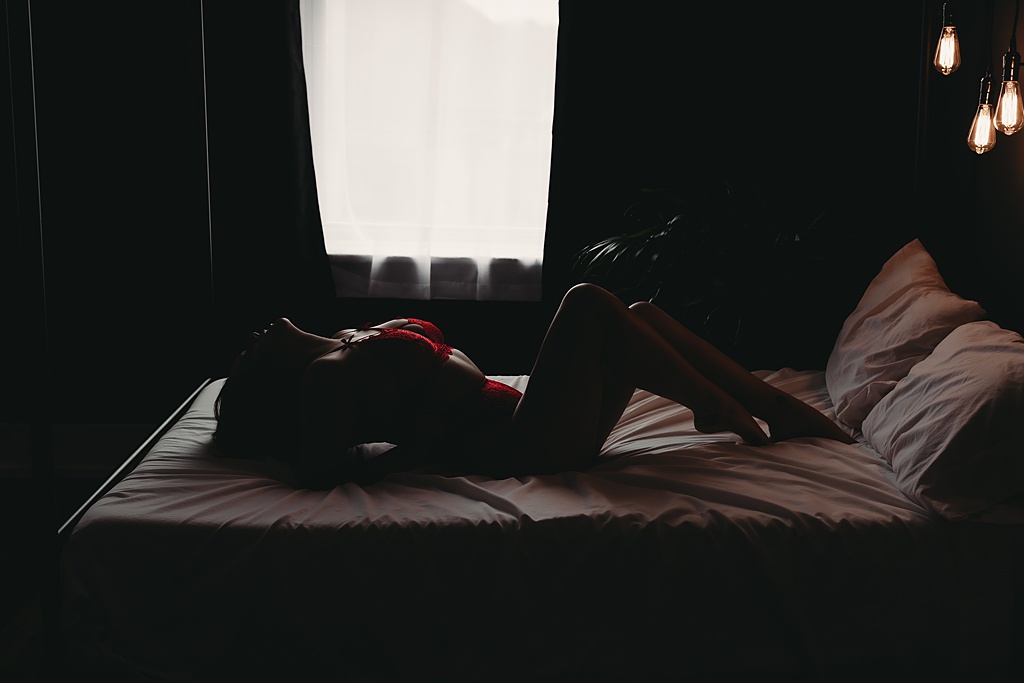 woman laying in bed wearing red