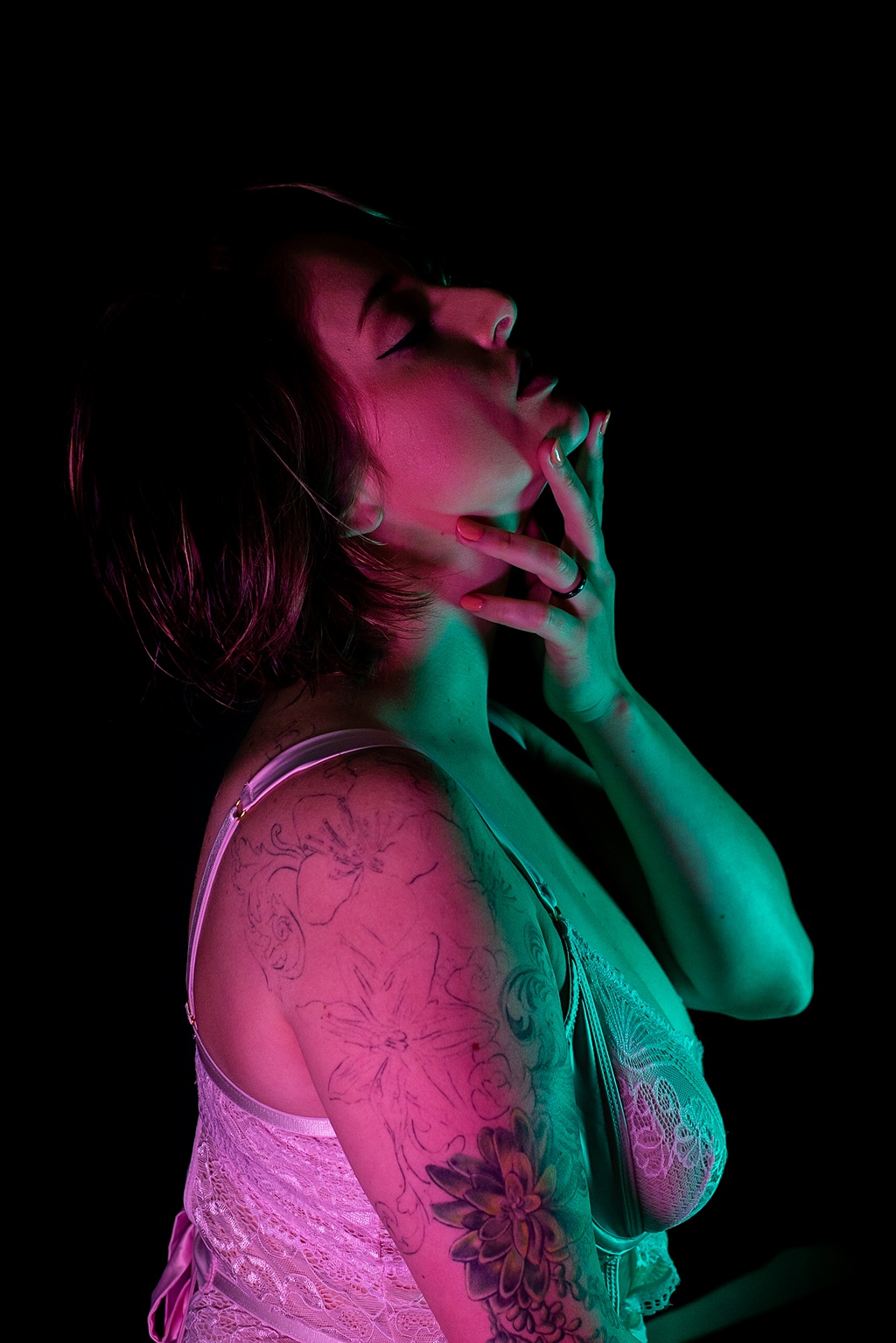 woman posing for Grand Haven MI boudoir shoot in neon lights
